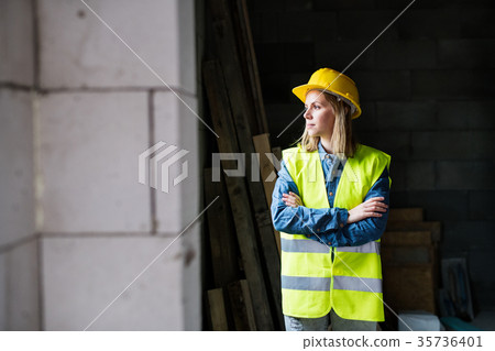 Young woman worker on the construction site. 35736401