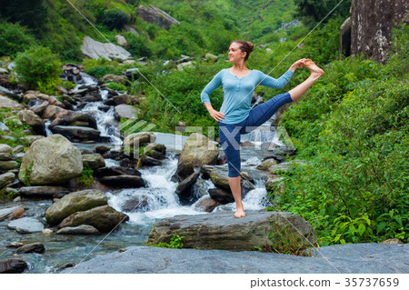 Woman doing Ashtanga Vinyasa Yoga asana outdoors 35737659