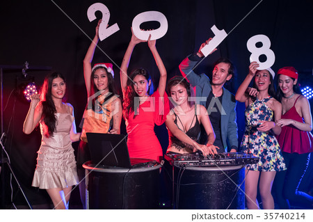 Teenagers are celebrating at the night party. 35740214