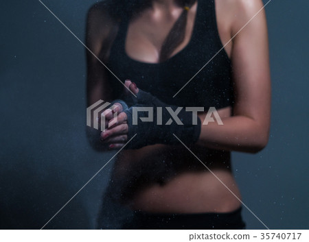 Young fighter boxer fit girl wearing hand bandage 35740717