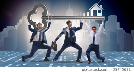 Businessmen holding giant key in real estate 35745681