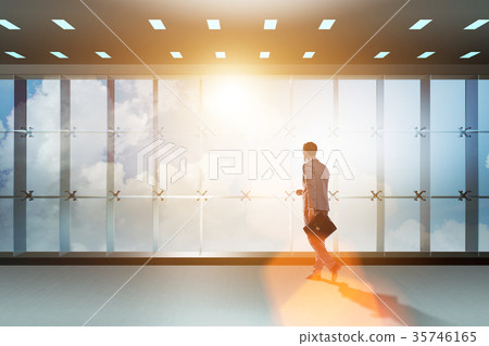 Businessman in front of office window thinking of 35746165