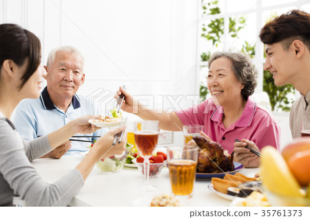 Happy family having dinner together. 35761373