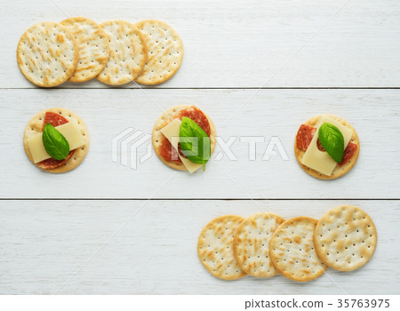 Crackers with cheese and  salami 35763975