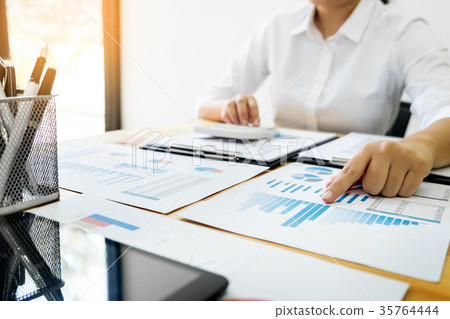 Businesswoman working in office typing on keyboard, female hands Businesswoman working in office typing on keyboard, female hands 35764444