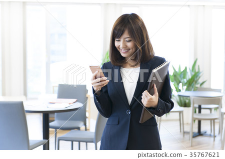 Young woman working Young woman playing smartphone Young woman working Young woman playing smartphone 35767621