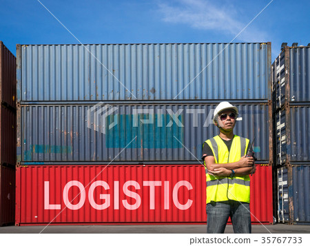 Foreman standing front Containers box from Cargo freight ship fo Foreman standing front Containers box from Cargo freight ship fo 35767733