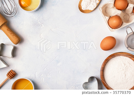 Ingredients for baking - flour wooden spoon, eggs Ingredients for baking - flour wooden spoon, eggs 35770370