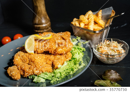 Delicious schnitzel served with french fries Delicious schnitzel served with french fries 35770730