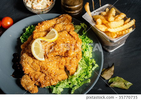 french fries and coleslaw with parmesan schnitzel french fries and coleslaw with parmesan schnitzel 35770735