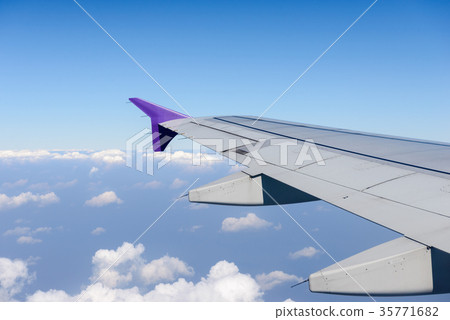 Wing of the plane flying above the clouds. Wing of the plane flying above the clouds. 35771682