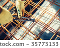 Construction site with worker using wire rod 35773133