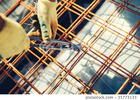 Construction site with worker using wire rod 35773133