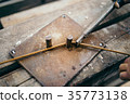 worker using industrial tools for bending clamp 35773138