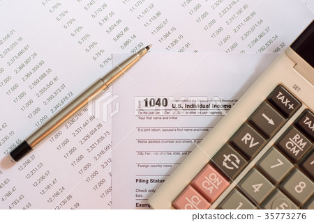 US tax form with pen and calculator US tax form with pen and calculator 35773276