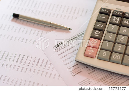 US tax form with pen and calculator US tax form with pen and calculator 35773277