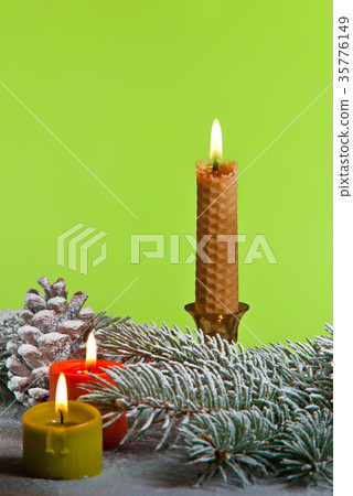 Three Christmas Candles on the Green Background Three Christmas Candles on the Green Background 35776149