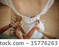 Morning bride. maid of honor helping the bride 35776263