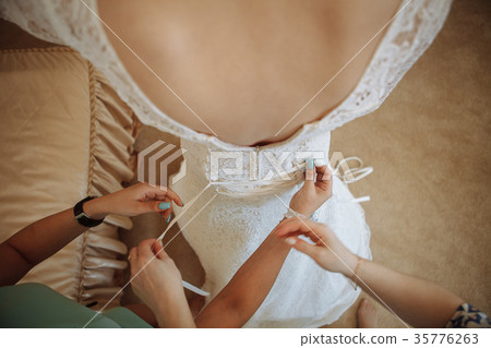 Morning bride. maid of honor helping the bride Morning bride. maid of honor helping the bride 35776263