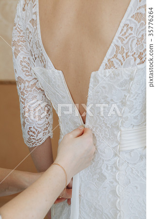 Mother Zipping Up Bride's whighte Wedding Dress Mother Zipping Up Bride's whighte Wedding Dress 35776264