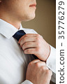 Businessman in white shirt tying the necktie 35776279