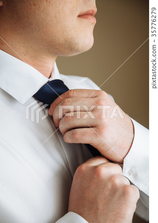 Businessman in white shirt tying the necktie 35776279