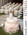 a multilevel white wedding cake with pink flowers 35776331