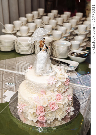 a multilevel white wedding cake with pink flowers a multilevel white wedding cake with pink flowers 35776331