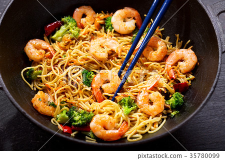 Stir fried noodles with shrimps and vegetables Stir fried noodles with shrimps and vegetables 35780099