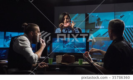 Security guards watching the surveillance cameras Security guards watching the surveillance cameras 35786360