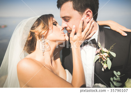Wedding couple, groom, bride with bouquet posing 35790107