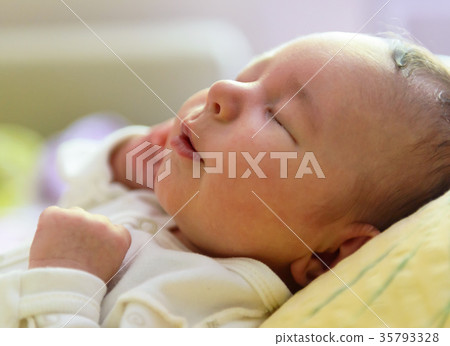 Newborn girl sleeping peacefully 35793328