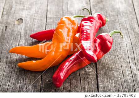 Orange and red peppers. 35795408