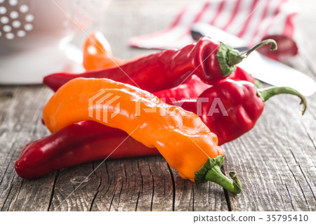 Orange and red peppers. 35795410