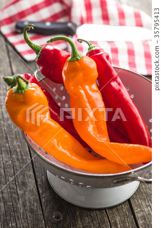 Orange and red peppers. 35795413