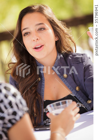 Expressive Young Adult Woman Having Drinks and Talking with Her 35796941