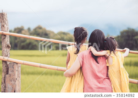 Mother and two asian girls looking at nature Mother and two asian girls looking at nature 35814892