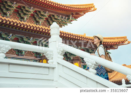 Asian woman walking up to visiting temple Asian woman walking up to visiting temple 35815607