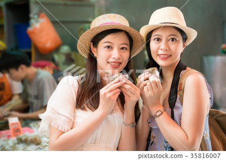 Girls visiting eating local food herbal cake Girls visiting eating local food herbal cake 35816007