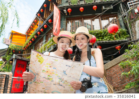 two Asian women tourist looking on map two Asian women tourist looking on map 35816041