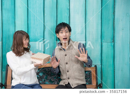 Surprised man giving a present 35817156