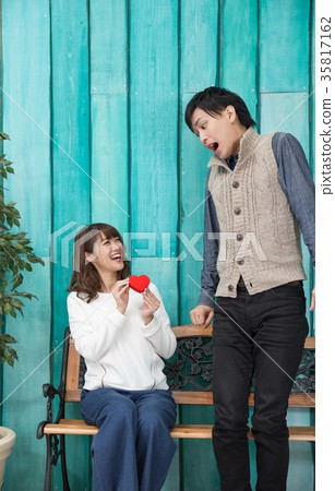 Surprised man giving a present 35817162