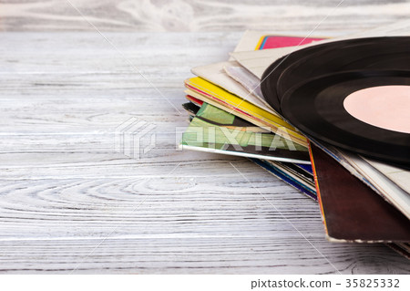 Old vinyl record on wooden background. Retro style 35825332