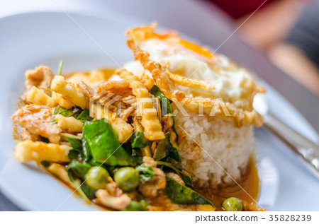 Rice topped with stir fried hot and spicy pork  35828239