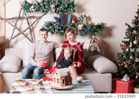 Portrait of young friendly family looking at 35833995