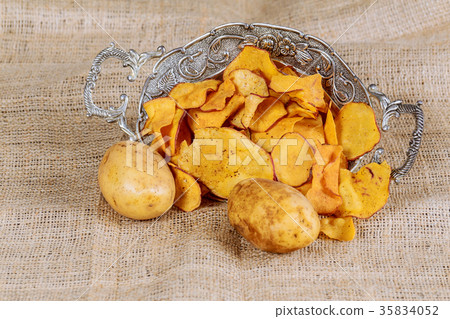 Heap of Paprika Potato Chips on rustic background Heap of Paprika Potato Chips on rustic background 35834052