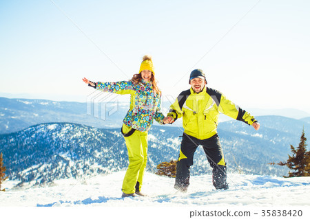 Couple jumping in the winter in the mountains Couple jumping in the winter in the mountains 35838420