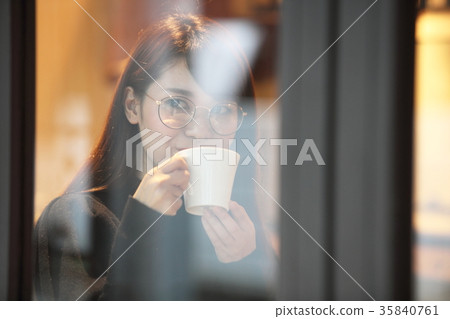 Women who drink coffee at a cafe 35840761