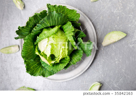 Fresh green cabbage in metal plate on grey Fresh green cabbage in metal plate on grey 35842163