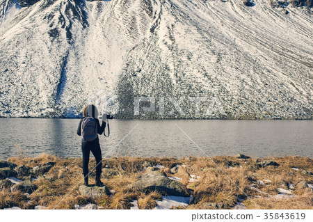 A woman photographer with camera on lake in Swis A woman photographer with camera on lake in Swis 35843619